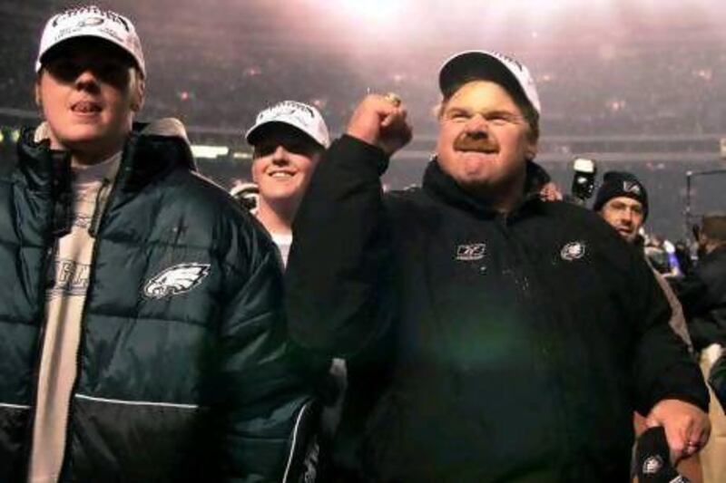 In this Dec. 30, 2001 photo, Philadelphia Eagles head coach Andy Reid, right, reacts to the crowd as he and his sons Garrett, left, and Britt, centre, walk off the field with him. Garrett Reid was found dead at the Philadelphia Eagles' training facility in his dorm room on Sunday. He was working as an unofficial assistant with the team.