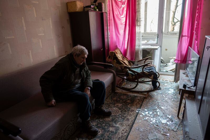 Volodymyr, 80, rests inside his apartment, which was damaged by shelling, in Kyiv. AP