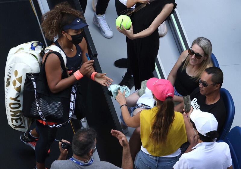 Naomi Osaka signs autographs after defeating Ons Jabeur in the third round match at the Australian Open. PA