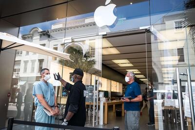 CHARLESTON, SC - MAY 13: A security guard takes the temperature of a customer outside the Apple Store on May 13, 2020 in Charleston, South Carolina. Customers had their temperatures taken and were required to wear masks at the South Carolina store, as locations in Idaho, Alabama, and Alaska reopened as well following forced closures due to the coronavirus.   Sean Rayford/Getty Images/AFP
== FOR NEWSPAPERS, INTERNET, TELCOS & TELEVISION USE ONLY ==
