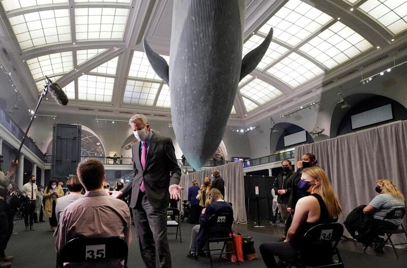 New York Mayor Bill de Blasio talks to people who just got vaccinated against the coronavirus disease while standing under the model of a blue whale during a tour around the COVID-19 vaccination site in the Milstein Family Hall of Ocean Life, at the American Museum of Natural History in New York, U.S., April 23, 2021. Picture taken April 23, 2021. Richard Drew/Pool via REUTERS