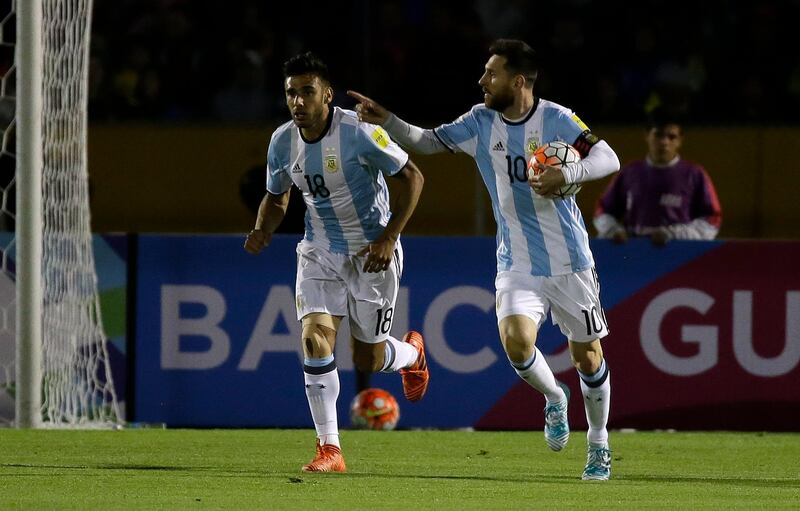 Lionel Messi runs with the ball after scoring against Ecuador. Fernando Vergara / AP Photo
