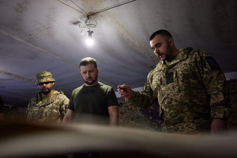 Ukrainian President Volodymyr Zelenskyy, centre, visits the military during a trip to the Zaporizhzhia region. AFP