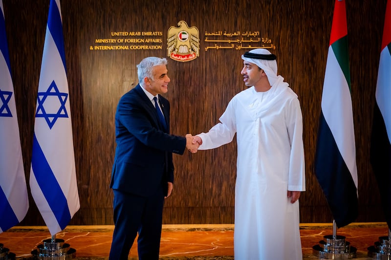 Israel's Foreign Minister Yair Lapid shakes hands with UAE's Foreign Minister Sheikh Abdullah bin Zayed Al Nahyan in Abu Dhabi. WAM via Reuters