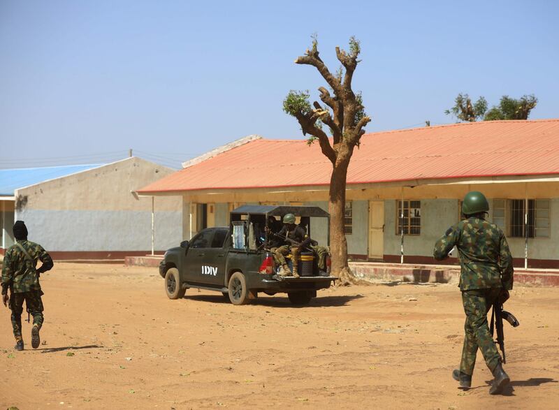 Nigerian soldiers walk inside the school.  AFP