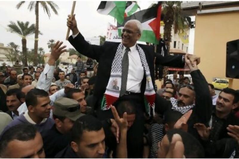 Saeb Erekat, the Palestinian Authority's chief negotiator, is carried during a rally upon his return from Cairo to Jericho in January this year. Mr Erekat initially accused Al Jazeera of misrepresenting quotes and making up others in its coverage of "The Palestine Papers", its name for what it says are leaked documents showing the Palestinians giving way on major issues in talks with Israel. Ammar Awad / Reuters