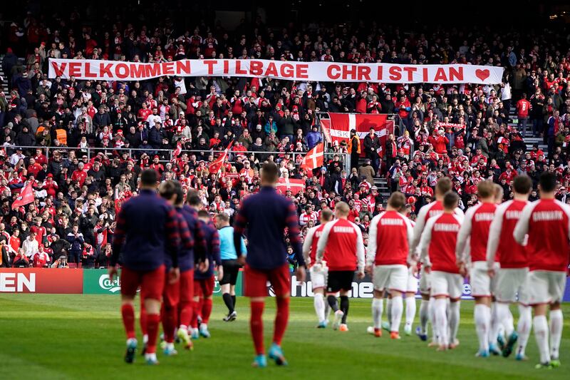 A banner reading 'Welcome back Christian', dedicated to Christian Eriksen. EPA