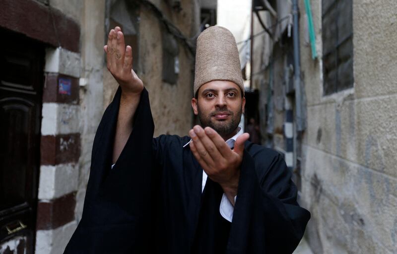 Mahmoud Al Kharrat, 34, dances in costume. AFP