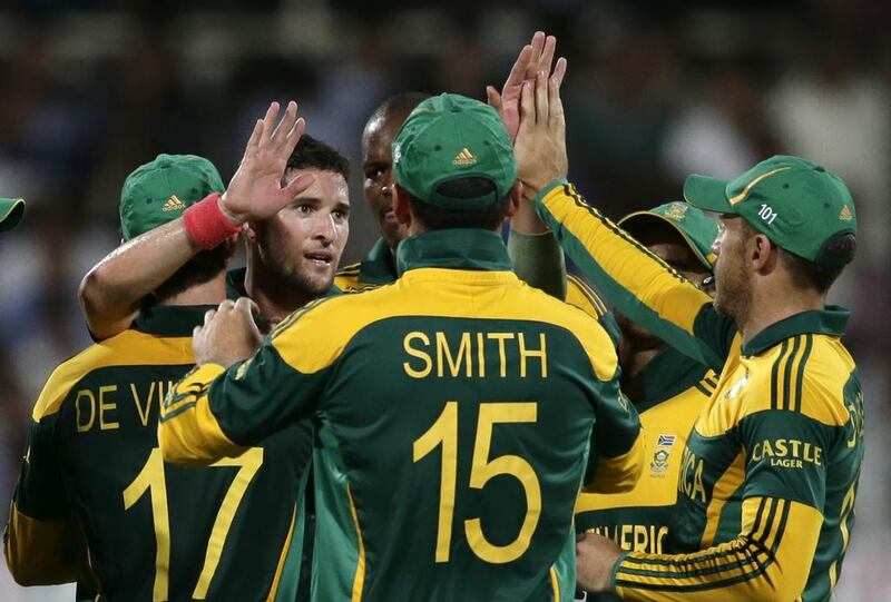 Wayne Parnell, second from left, and his South Africa teammates had a memorable win to celebrate. Photos by Hassan Ammar / AP Photo