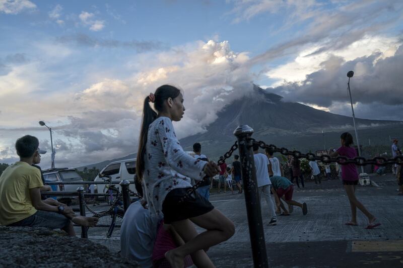 Visitors and residents flock to a viewing area to see the Mayon volcano as it erupts on January 26, 2018, in Albay, Philippines. Jes Aznar / Getty Images