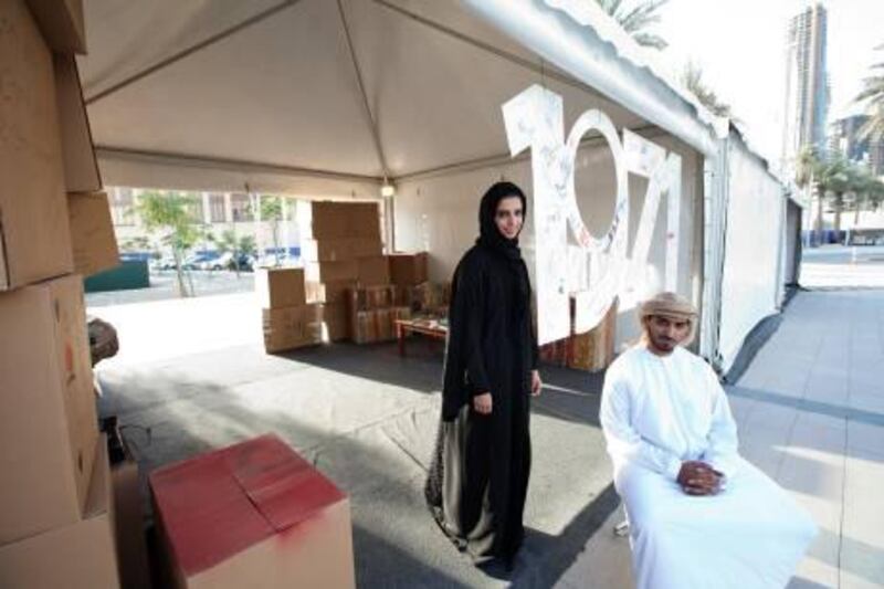 Dubai, Feb 14th, 2012 -- (L to R)  Founding members of 1971 charity group Hassa Bintamim and Almurr Almarri are photographed at their donation collection tent at Dukkan Al Downtown in Dubai, February 14, 2012. The group's aim is to "give back" to their country. (Sarah Dea/ The National)