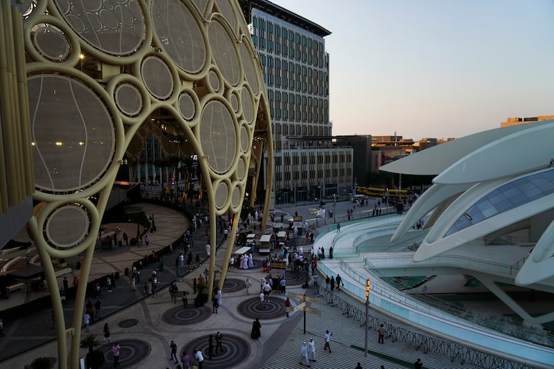 Evening visitors admire the spectacular design on show at Expo 2020 Dubai. AP Photo