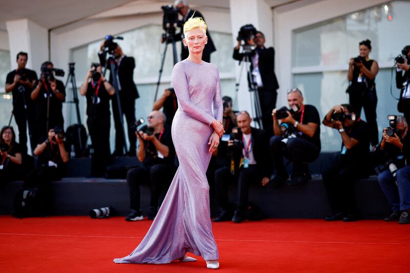 In a shimmering, lilac Haider Ackermann gown, Tilda Swinton walks the red carpet for 'The Eternal Daughter'. Reuters