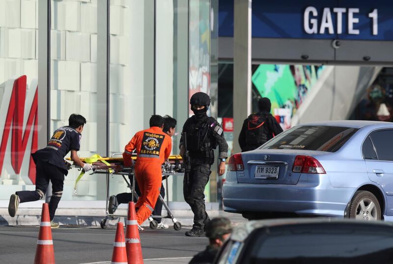 Medics carry a stretcher towards Terminal 21 Korat mall as commando soldiers work the scene of a shooting at the mall in Nakhon Ratchasima, Thailand. AP Photo