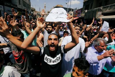 Protesters chant slogans during a protest against the new income tax law and high fuel prices, in Amman, Jordan June 1, 2018. The banner reads in Arabic "we do not have money". REUTERS/Muhammad Hamed
