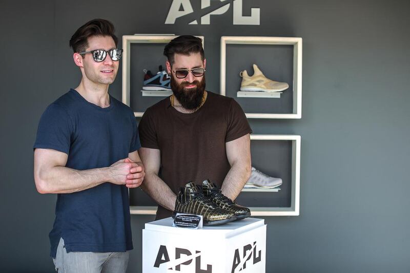 APL’s Ryan Goldston, left, and his twin Adam at Level Shoes in The Dubai Mall with their crocodile-skin trainers. Courtesy APL & Level Shoes 