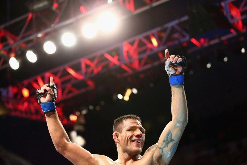 Rafael dos Anjos celebrates his win against Anthony Pettis in the lightweight title bout at UFC 185 on Saturday in Dallas, Texas. Ronald Martinez / Getty Images / AFP / March 14, 2015 