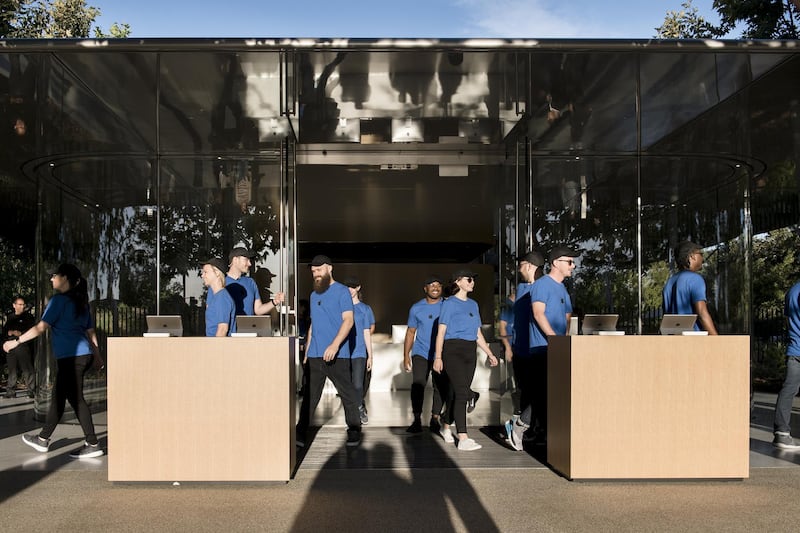 Employees walk out to kiosks ahead of the Apple event. Bloomberg