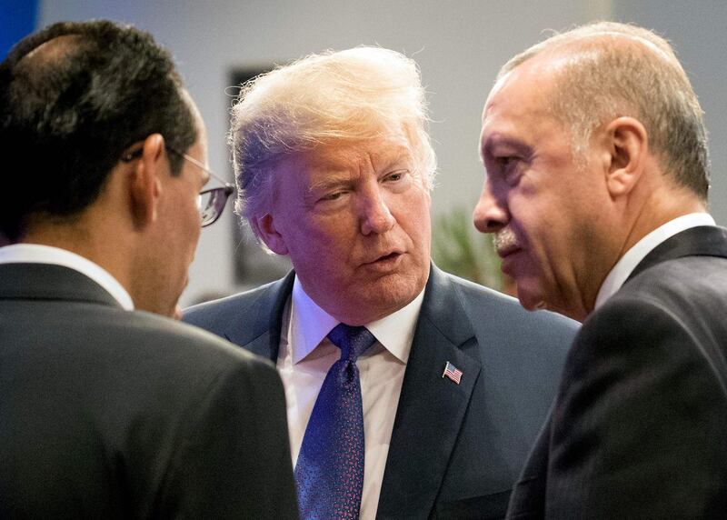 (FILES) In this file photo taken on July 10, 2018 US President Donald Trump (2ndR) speaks with Turkey's President Recep Tayyip Erdogan (R) during a working dinner in Brussels, during the North Atlantic Treaty Organization summit. - Trump said on August 10, 2018, he had doubled steel and aluminum tariffs on Turkey, adding to pressure on that nation's troubled economy amid a diplomatic row with Washington. "I have just authorized a doubling of Tariffs on Steel and Aluminum with respect to Turkey as their currency, the Turkish Lira, slides rapidly downward against our very strong Dollar!" Trump said on Twitter. (Photo by BENOIT DOPPAGNE / POOL / AFP)