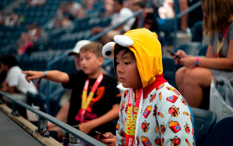 A boy dressed as a Fortnite character attends the 2019 Fortnite World Cup Finals - Round Two on July 27, 2019, at Arthur Ashe Stadium, in New York City. / AFP / Johannes EISELE
