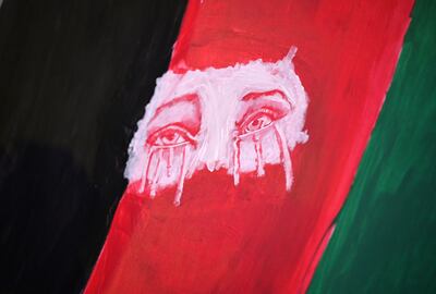 Tearful eyes are painted on a flag as members of the Los Angeles Afghan community and their supporters hold a vigil for Afghanistan outside the West LA Federal Building. AFP