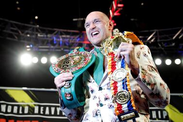 Tyson Fury poses with his belts after beating Deontay Wilder in February. Reuters