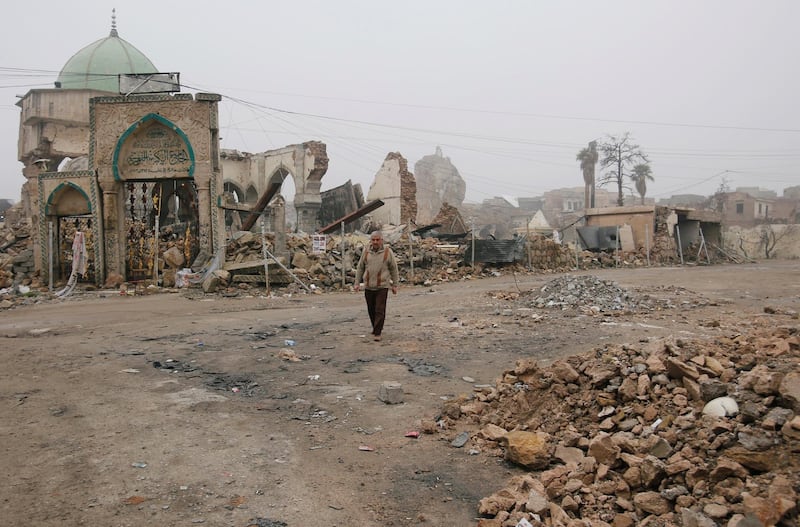 A man walks next to the destroyed Al Nuri mosque in February 2019. Reuters