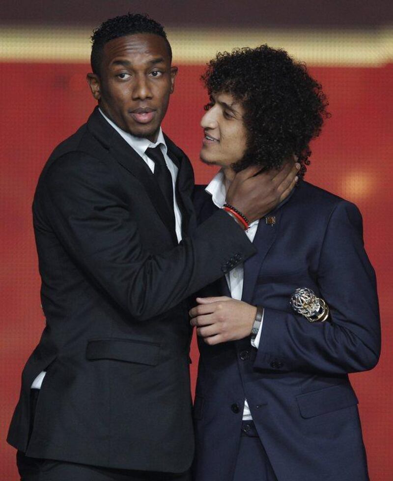 Ahmed Khalil, left, embraces UAE teammate Omar Abdulrahman after being named the AFC Asian Player of the Year. Altaf Qadri / AP Photo