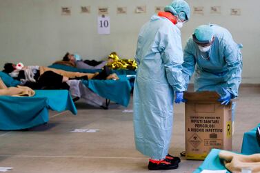 Patients lie on beds in one of the emergency structures that were set up to ease procedures at the Brescia hospital, northern Italy, Thursday, March 12, 2020 AP