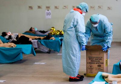 Patients lie on beds in one of the emergency structures that were set up to ease procedures at the Brescia hospital, northern Italy, Thursday, March 12, 2020. Italians woke up to yet further virus-containment restrictions after Premier Giuseppe Conte ordered restaurants, cafes and retail shops closed after imposing a nationwide lockdown on personal movement. For most people, the new coronavirus causes only mild or moderate symptoms, such as fever and cough. For some, especially older adults and people with existing health problems, it can cause more severe illness, including pneumonia. (AP Photo/Luca Bruno)