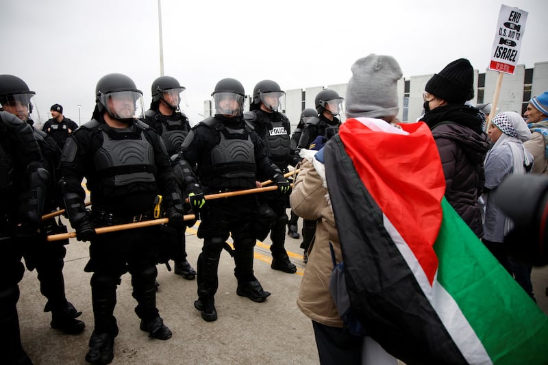 Protestors face-off against police during a rally for a Cease Fire in Gaza outside a UAW union hall during a visit by U. S.  President Joe Biden in Warren, Michigan. Reuters
