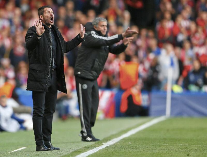 Atletico Madrid manager Diego Simeone and Chelsea coach Jose Mourinho react during their team's Champions League semi-final match on Wednesday. Stefan Wermuth / Reuters / April 30, 2014