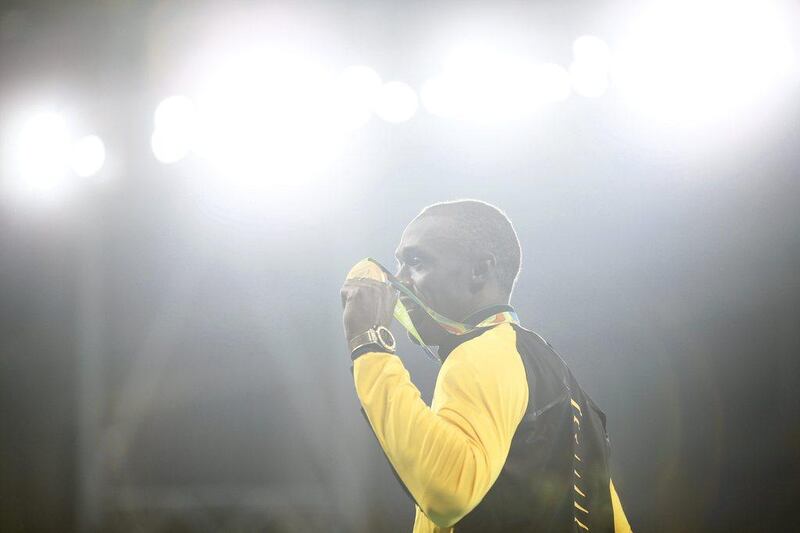 Usain Bolt of Jamaica poses with his gold medal on the podium on Friday. Yoan Valat / EPA / August 19, 2016  