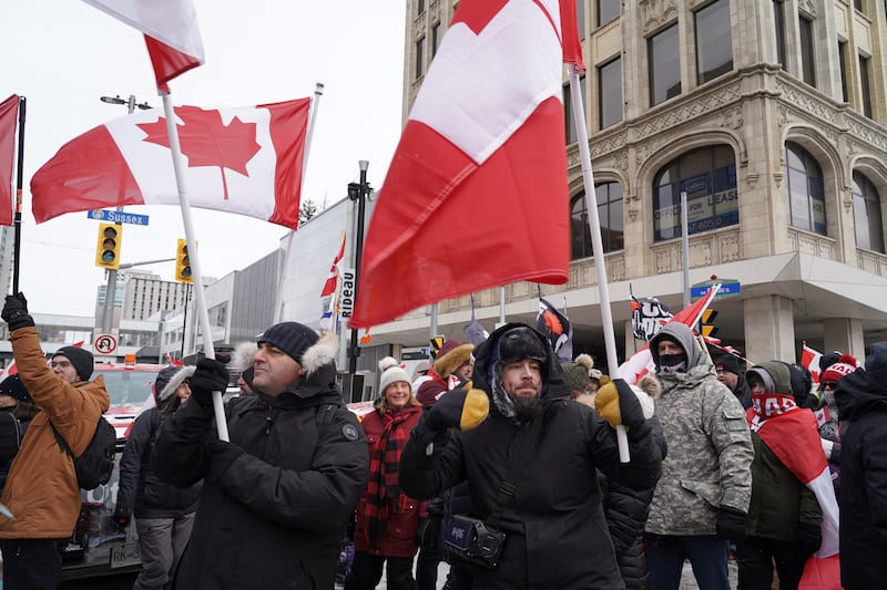 A man holds a boombox and a Canadian flag. Willy Lowry / The National.