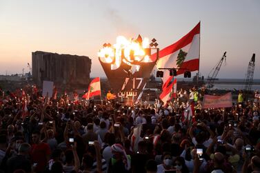 Anti-government demonstrators with a metal sculpture in Beirut spelling out the word "revolution" during a protest as Lebanese mark the anniversary of nationwide protests against deteriorating economy and corruption. Reuters