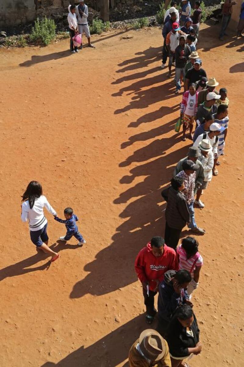 People stand in line to vote during elections in Antananarivo, Madagascar in the first elections since the 2009 coup. Schalk van Zuydam / AP Photo