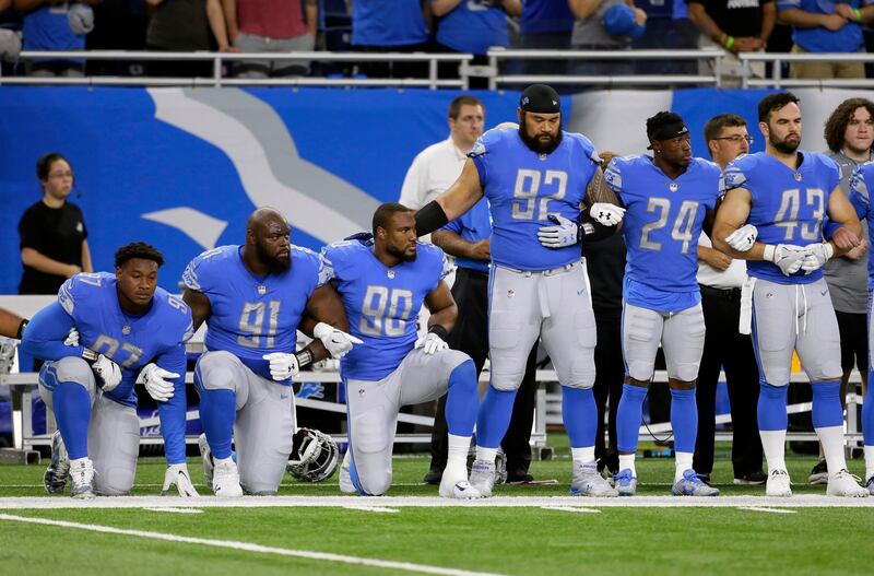 Detroit Lions defensive end Armonty Bryant (97), defensive tackle A'Shawn Robinson (91) and defensive end Cornelius Washington (90) take a knee during the national anthem before an NFL football game against the Atlanta Falcons, Sunday, Sept. 24, 2017, in Detroit. (AP Photo/Duane Burleson)