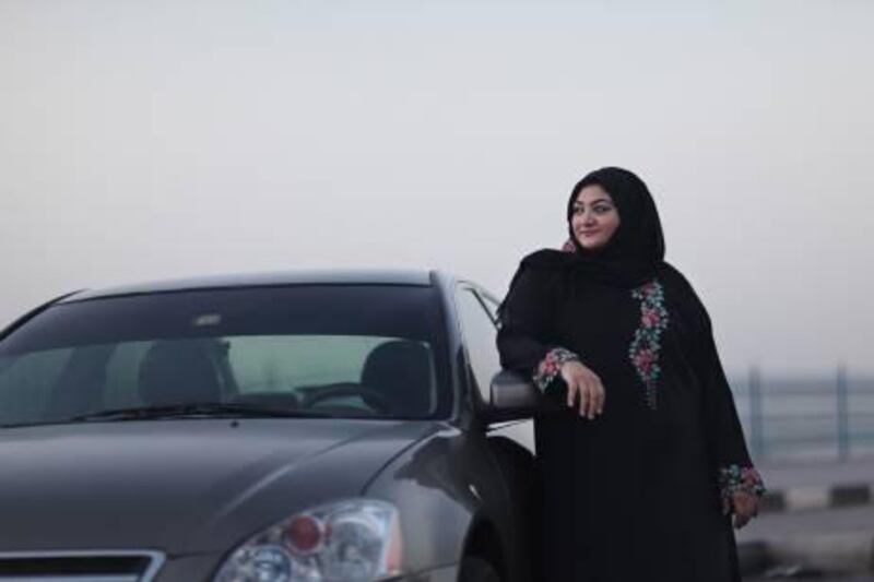 United Arab Emirates - Ajman - November 7, 2010.

MOTORING: Shaima Al Sayed (cq-al), 34, of Ajman, poses with her 2005 Nissan Altima on the Ajman Corniche on Sunday, November 7, 2010. "I'm so comfortable with the dimensions of this car," said Al Sayed who leads a women's auto tour of the UAE every National Day. "It's like a part of me. I never scratch or bump my car." Amy Leang/The National