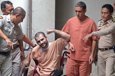 Saeid Moradi gestures to the media next to fellow Iranian prisoner Mohammad Khazaei during an appearance at a court in Bangkok on August 22, 2013, over a bomb plot in the Thai capital. AFP