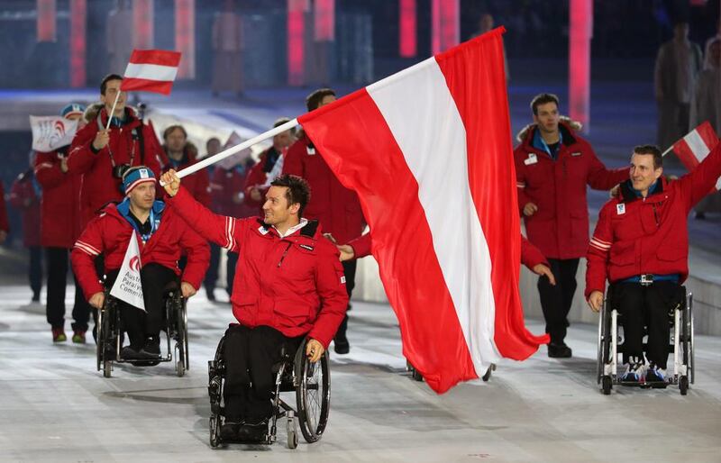 Team Austria with flag bearer Philipp Bonadimann enter the arena at the opening ceremonies for the 2014 Winter Paralympic Games on Friday. Sergei Chirikov / EPA / March 7, 2014