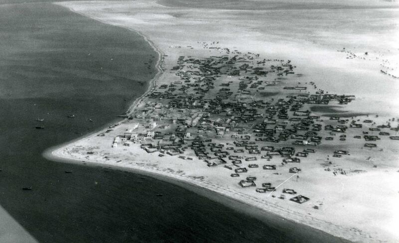 Abu Dhabi, then part of the Trucial States, pictured from above in the late 1950s / early 1960s. The emirate's coastline and palm dwellings can be seen. Photo: BP Archive