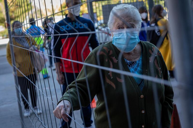 A woman lines up for a rapid antigen test for COVID-19 in the southern neighbourhood of Vallecas in Madrid, Spain, on September 29. Madrid has a rate of infection 2.5 times higher than the national average, which is already three times the European average, including the UK. Bernat Armangue / AP