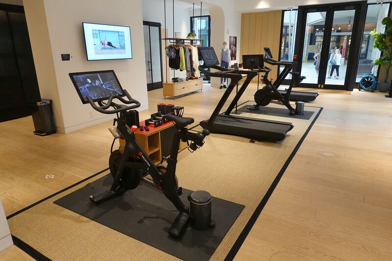 A Peloton showroom displays bikes and treadmills. The company's shares tumbled on Thursday, January 20, after a media report said the exercise and treadmill company was temporarily halting production of its connected fitness products amid waning consumer demand. Getty Images / AFP