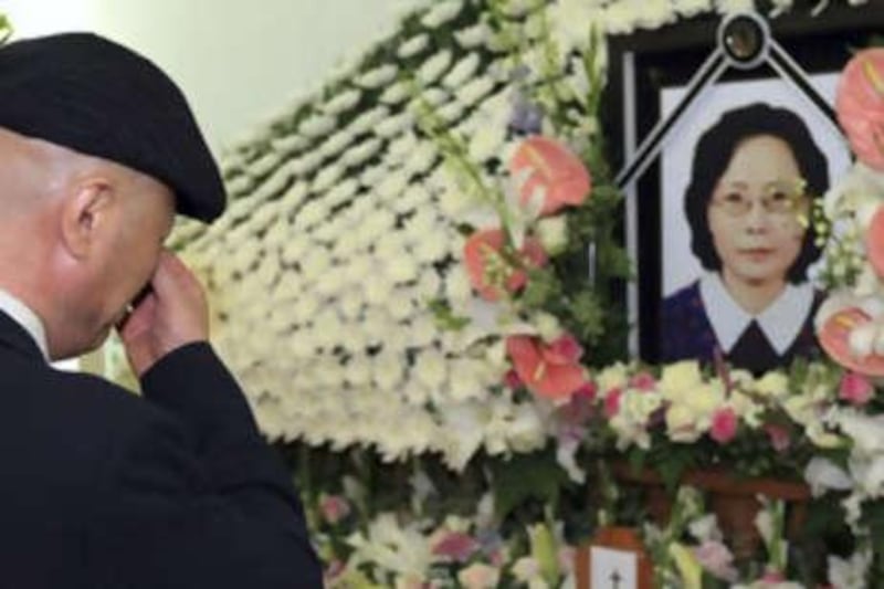 Bang Young-min, husband of Park Wang-ja, who was shot and killed at a mountain resort in North Korea, cries in front of Park's portrait during her funeral service at a hospital in Seoul.