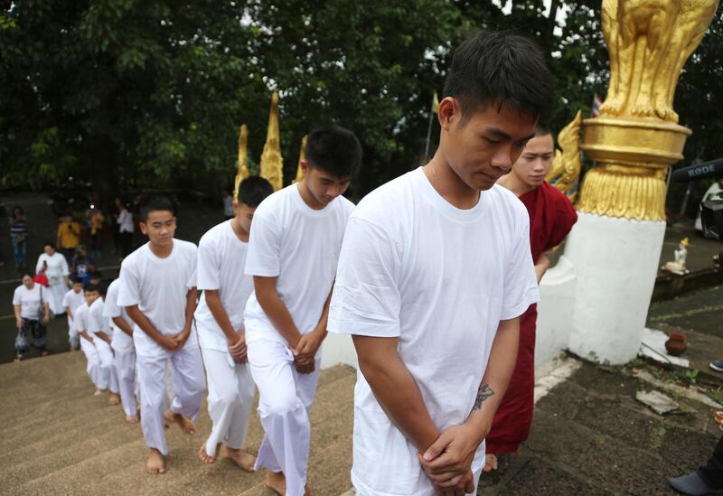 Chantawong, front, and members of the team arrive to attend a Buddhist ceremony.  AP Photo