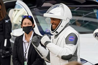 NASA astronaut Victor Glover reacts to family members as leaves the Operations and Checkout Building with fellow crew members for a trip to Launch Pad 39-A and planned liftoff on a SpaceX Falcon 9 rocket with the Crew Dragon capsule on a six-month mission to the International Space Station Sunday, Nov. 15, 2020, at the Kennedy Space Center in Cape Canaveral, Fla. (AP Photo/John Raoux)