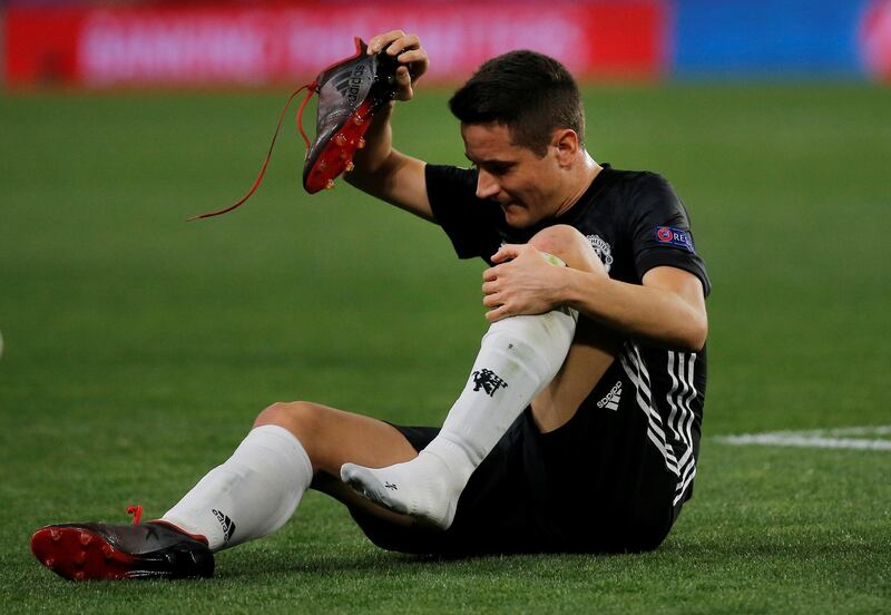 Soccer Football - Champions League Round of 16 First Leg - Sevilla vs Manchester United - Ramon Sanchez Pizjuan, Seville, Spain - February 21, 2018   Manchester United's Ander Herrera takes off his boot after sustaining an injury    REUTERS/Jon Nazca