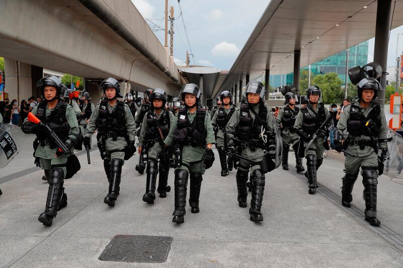 Riot police patrol outside the airport in Hong Kong. AP