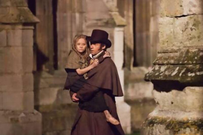 Isabelle Allen as young Cosette and Hugh Jackman as Jean Valjean in Les Misérables. Courtesy Universal Pictures