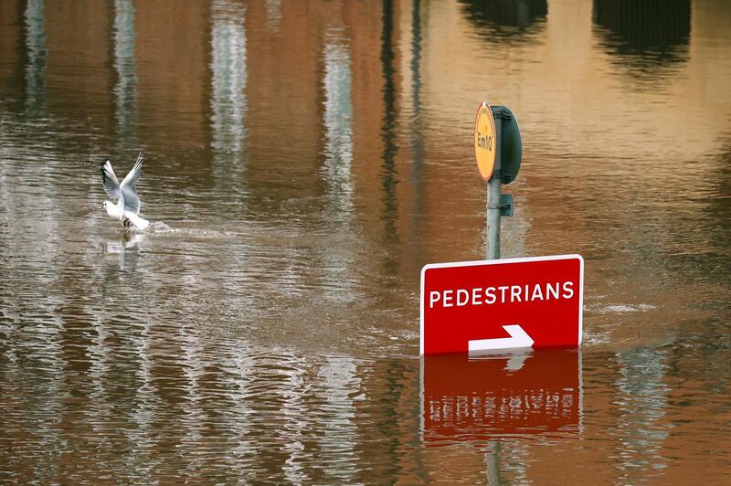 A road sign is partially submerged on a flooded street in York. Reuters